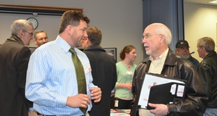 A District contract representative speaks with a small business representative during the open house.